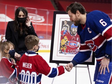 Montreal Canadiens defenseman Shea Weber (6) is greeted by his family during a presenting of a silver stick to mark his 100th NHL game, at the Bell Centre in Montreal on Thursday, Feb. 4, 2021.