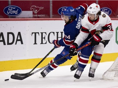 Ottawa Senators centre Micheal Haley (38) tips the puck away from Montreal Canadiens left wing Phillip Danault (24) at the Bell Centre in Montreal on Thursday, Feb. 4, 2021.