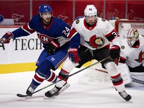 Montreal Canadiens left wing Phillip Danault (24) calls out towards the ref as Ottawa Senators centre Colin White (36) hangs on to him at the Bell Centre in Montreal on Thursday, Feb. 4, 2021.