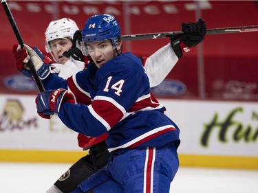 Montreal Canadiens centre Nick Suzuki (14) knocks Ottawa Senators defenseman Mike Reilly (5) off the play at the Bell Centre in Montreal on Thursday, Feb. 4, 2021.