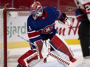 Montreal Canadiens goaltender Carey Price looks back to see the Ottawa Senators have scored their third goal against him in Montreal on Feb. 4, 2021.