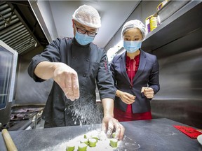 Serena Zhang, president of the Young Chinese Professionals Association, watches as chef Peiwei Li of Qing Hua Dumpling prepares shells prior to a dumpling making workshop in LaSalle.