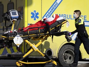 Urgences-santé paramedics unload a patient at Notre-Dame Hospital.