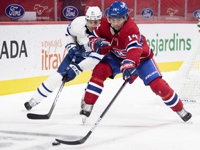 Nick Suzuki chases loose puck in front of Maple Leafs' John Tavares during first period at the Bell Centre on Wednesday.