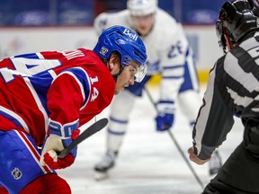 Montreal Canadien Nick Suzuki lines up for a faceoff during second period of an NHL game against the Toronto Maple Leafs in Montreal Feb. 10, 2021.