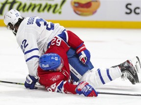 Toronto Maple Leafs' Zach Bogosian pins Montreal Canadiens' Artturi Lehkonen to the ice during third period in Montreal on Feb. 10, 2021.