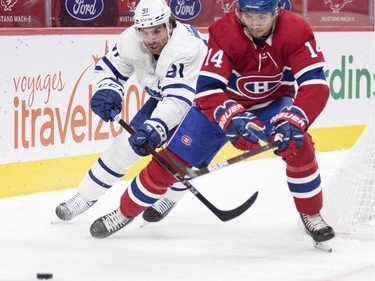 Nick Suzuki chases loose puck in front of Toronto Maple Leafs' John Tavares during first period at the Bell Centre on Wednesday, Feb. 10, 2021.