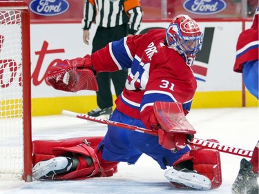 Carey Price looks back as puck passes through his crease during second period at the Bell Centre on Wednesday, Feb. 10, 2021.