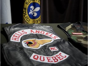 Surete du Quebec display Hells Angels vests as they speak to the media after a series of raid on the Hells Angels in Montreal on Tuesday April 24, 2018.