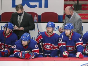 Canadiens head coach Claude Julien (right) and associate coach Kirk Muller take notes during third period of Thursday night’s 3-0 loss to the Edmonton Oilers at the Bell Centre.
