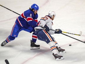 Edmonton Oilers star Connor McDavid battles with Montreal Canadiens defenceman Ben Chiarot during first period in Montreal on Feb. 11, 2021.