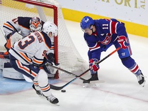 Canadiens' Brendan Gallagher tries to get a backhand past Edmonton Oilers  Ryan Nugent-Hopkins and goalie Mike Smith during second period in Montreal on Feb. 11, 2021.