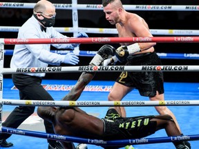 David Lemieux, right, knocks down Francy Ntetu, bottom, at a boxing event on Oct. 10, 2020, in Shawinigan.