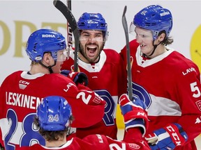 Laval Rocket's Joel Teasdale celebrates his goal with teammates Otto Leskinen, Cale Fleury, right, and Jake Lucchini during third period against the Belleville Senators in Montreal on Feb. 12, 2021.