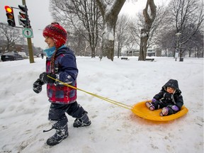 Jibran Khan pulls his sister Mira through Trenholme Park in the Notre-Dame-de-Grace borough of Montreal Tuesday February 16, 2021.