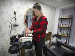 Kristyne Tardiff prepares hair colour for a client in her home salon in St-Jean-sur-Richelieu, south of Montreal, on Saturday, Feb. 20, 2021. She lost her hairdressing salon during the pandemic, as well as her two grandparents, one of whom died of COVID-19.
