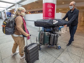 Danielle Beaudoin and her husband, Serge Gauthier, arrive at Montréal–Trudeau International Airport in Dorval on Sunday Feb. 21, 2021. The couple cut short their winter stay in the Dominican Republic to avoid the new government regulation coming into effect the next day that would have required them to quarantine in a designated hotel while they await results of a COVID-19 test.