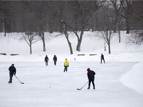 With a near empty ice surface available to them, two friends pass the puck around in Parc Lafontaine on Feb. 22, 2021.