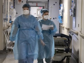 Nurses do their rounds at Verdun Hospital’s COVID-19 unit. On Feb. 25 last year, when Patient One arrived, the triage nurse came quickly, wearing a mask, gown and gloves, and escorted the woman to the ER. Things moved with a quiet, controlled urgency.
