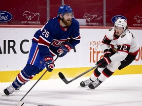 Canadiens’ defenceman Jeff Petry is watched by Ottawa Senators defenceman Thomas Chabot during game Thursday night at the Bell Centre.