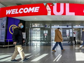 Travellers walk through Montreal's Trudeau airport, Friday, December 18, 2020.