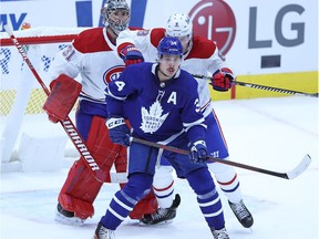 Canadiens defenceman Ben Chiarot tries to move Maple Leafs forward Auston Matthews from the front of the net while goalie Carey Price looks on during season-opening game in Toronto on Jan. 13. The Leafs won the game 5-4 in overtime.