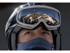 The National Alpine Ski Centre, where alpine events for the Beijing 2022 Winter Olympics are to be held, is reflected on a Chinese national skier's goggles in Yanqing district on Feb. 5.