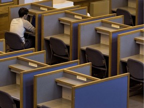 A student works on his laptop in the library at Dawson College.