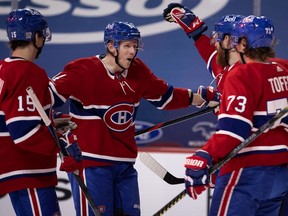 Montreal Canadiens right wing Corey Perry (94) celebrates with Canadiens centre Jesperi Kotkaniemi (15), defenceman Jeff Petry (26) and right wing Tyler Toffoli (73) after scoring against Vancouver Canucks goaltender Braden Holtby (49) during NHL action in Montreal on Monday, February 1, 2021.