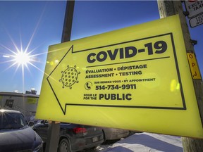 A sign points the way to the COVID-19 testing centre at the Jewish General Hospital on a sunny day in Montreal Monday Feb. 8, 2021.