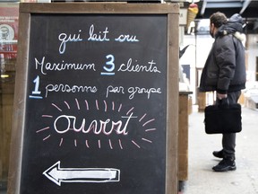 Large signs remind Montrealers that limits inside retails shops remain in effect at Jean-Talon Market.