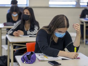 Masked students in French class at John F. Kennedy High School in Montreal Tuesday November 10, 2020. In January 2021, the Quebec government announced it would distribute procedural masks, like the one worn by the student in the foreground, to be worn by students and teachers.
