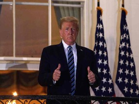 U.S. President Donald Trump gives two thumbs up from the Truman Balcony upon his return to the White House from Walter Reed Medical Center, where he underwent treatment for Covid-19, in Washington, D.C., on Oct. 5, 2020.