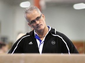 U.S. gymnastics coach John Geddert watches his students during a practice in Lansing, Michigan, on Dec. 14, 2011.