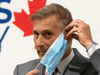 People’s Party of Canada Leader Maxime Bernier removes a mask as he arrives for a news conference in Ottawa, August 24, 2020.