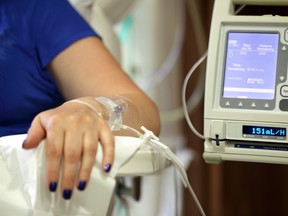 Infusion pump feeding IV drip into patient's arm.