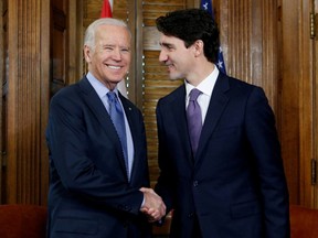 Canada's prime minister, Justin Trudeau (R), shakes hands with then-U.S. Vice President Joe Biden during a meeting in Trudeau's office on Parliament Hill in Ottawa, Ontario, Canada, December 9, 2016.