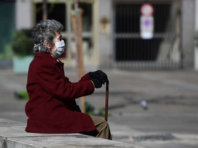 An elderly woman wearing a protective face mask