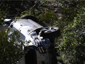 The vehicle driven by golfer Tiger Woods lies on its side in Rancho Palos Verdes, California, on February 23, 2021, after a rollover accident. - US golfer Tiger Woods was hospitalized Tuesday after a car crash in which his vehicle sustained "major damage," the Los Angeles County Sheriff's department said. Woods, the sole occupant, was removed from the wreckage by firefighters and paramedics, and suffered "multiple leg injuries," his agent said in a statement to US media.