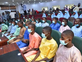 Abducted students of Government Science College Kagara sit in the state conference hall after being freed in Minna, Niger State, central Nigeria, on Saturday, Feb. 27, 2021. Kidnappers have freed 42 people, including 27 children, snatched from a school in central Nigeria 10 days ago, officials said on Saturday, a day after more than 300 schoolgirls were abducted by gunmen in the northwest.