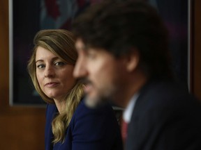 Economic Development and Official Languages Minister Mélanie Joly looks on as Prime Minister Justin Trudeau speaks during a news conference in Ottawa, Friday, October 2, 2020. The policy paper on official languages that Joly presented last week "had a little something for everyone," Tom Mulcair writes.