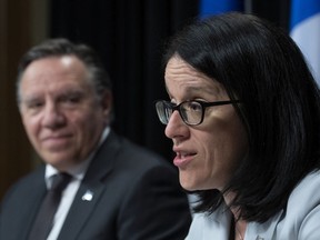 Sonia LeBel, Quebec's minister responsible for intergovernmental affairs, speaks as Premier François Legault looks on. "Legault seems to be trying to softly and de facto separate Quebec from Canada, bit by bit," Tom Mulcair writes.