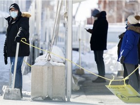 People wait to be tested for COVID-19 at a testing clinic in Montreal, Sunday, January 31, 2021.