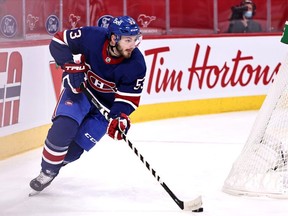 Canadiens' Victor Mete plays the puck against Toronto Maple Leafs during the first period at the Bell Centre on Saturday, Feb. 20, 2021.