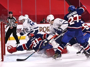 Canadiens goaltender Carey Price makes a save against Toronto Maple Leafs' Ilya Mikheyev (65) and Zach Hyman (11) and Alexander Romanov (27) during the first period at the Bell Centre in Montreal on Saturday, Feb. 20, 2021.