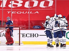 Feb 20, 2021; Montreal, Quebec, CAN; Toronto Maple Leafs center Auston Matthews (34) celebrates his goal against Montreal Canadiens goaltender Carey Price (31) with teammates during the second period at Bell Centre. Mandatory Credit: Jean-Yves Ahern-USA TODAY Sports