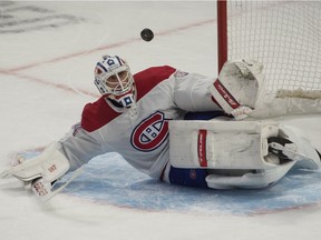 Canadiens goalie Jake Allen makes a save on a shot from Senators' Brady Tkatchuk in overtime at the Canadian Tire Centre in Ottawa on Sunday, Feb. 21, 2021.