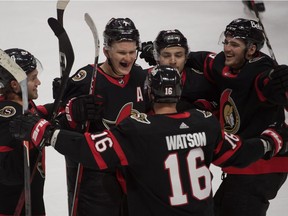 The Senators’ Brady Tkachuk celebrates with teammates after scoring in overtime for 3-2 win over the Canadiens Sunday night in Ottawa.