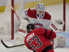 Montreal Canadiens' Jake Allen makes a save on a shot by Ottawa Senators right-wing Evgenii Dadonov during the third period at the Canadian Tire Centre in Ottawa on Feb. 6, 2021.