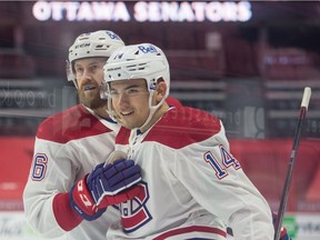 Canadiens' Nick Suzuki (14) celebrates with defenceman Jeff Petry his goal scored in the first period against the Senators at the Canadian Tire Centre in Ottawa on Sunday, Feb. 21, 2021.